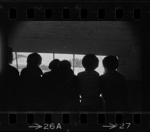 Students looking out window presumably from seized building during Brandeis University protest