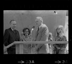 David S. Lewis, head of General Dynamics, speaking at christening ceremony for the USS Mount Vernon while Barry J. Shillito, Assistant Secretary of Defense and his wife, far left, look on