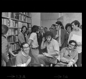 MIT official surrounded by SDS protesters and speaking inside a room