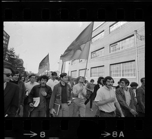 Chanting SDS members, armed with Viet Cong flags, approach main entrance of Massachusetts Institute of Technology protesting what they called "imperialist research"
