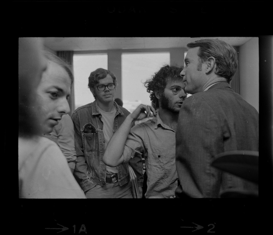 MIT SDS members gathered inside and speaking with a man during student demonstrations