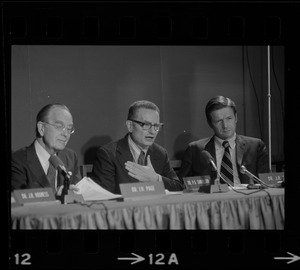 Dr. Paul Samuelson (center) addresses symposium at the B.U. Medical Center while Dr. Irvine Page (left) and J.R. Silber, Pres. of B.U. (right) listen