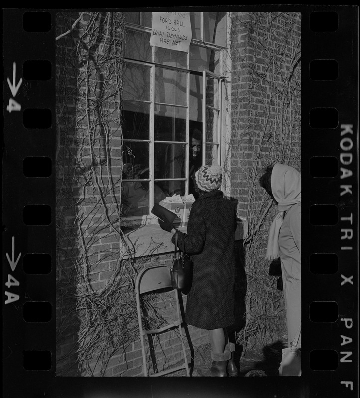 Brandeis University student speaking to a Black student protester through a window of Ford Hall during sit-in