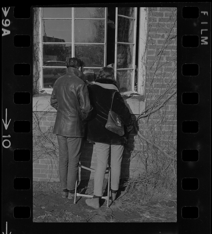 Brandeis University students speaking through a window of Ford Hall to a Black student protester during the sit-in