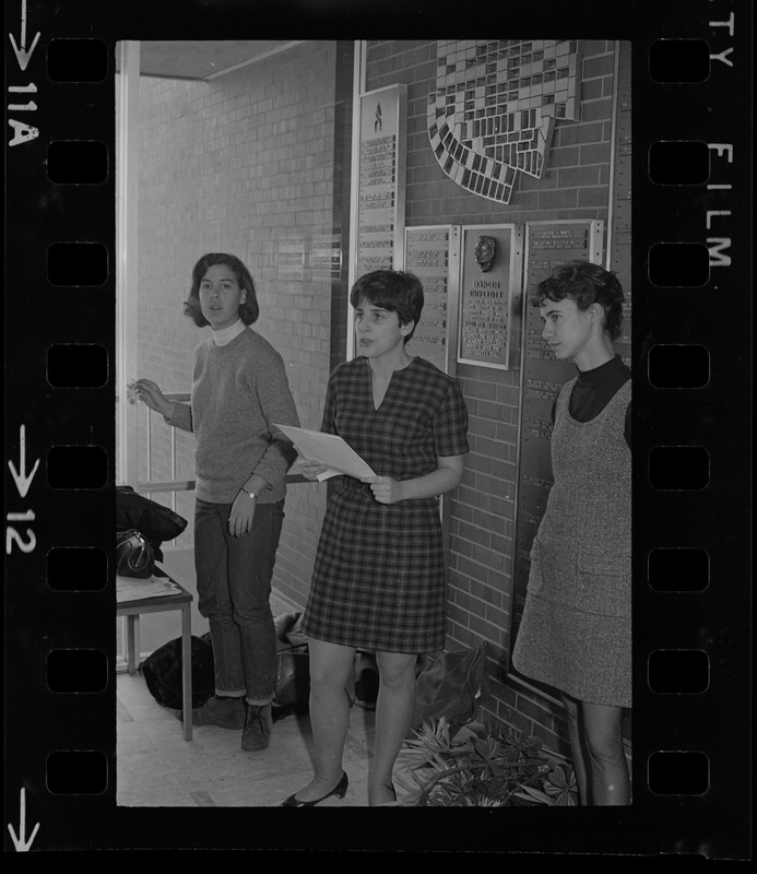 Brandeis University student speaking and holding papers during sit-in