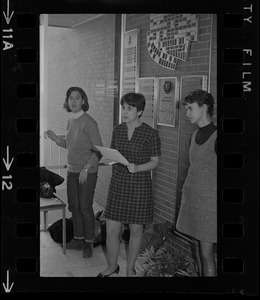 Brandeis University student speaking and holding papers during sit-in