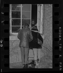 Brandeis University students speaking through a window of Ford Hall to a Black student protester during the sit-in