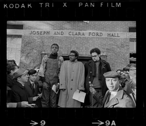 Reggie Sapp, Lloyd Daniels and Randall Bailey read the Ford Hall protesters' demands outside of Ford Hall during Brandeis University sit-in