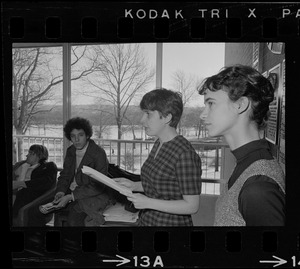 Student holds papers and speaks to a group inside the Bernstein-Marcus Administration Center during sit-in at Brandeis University