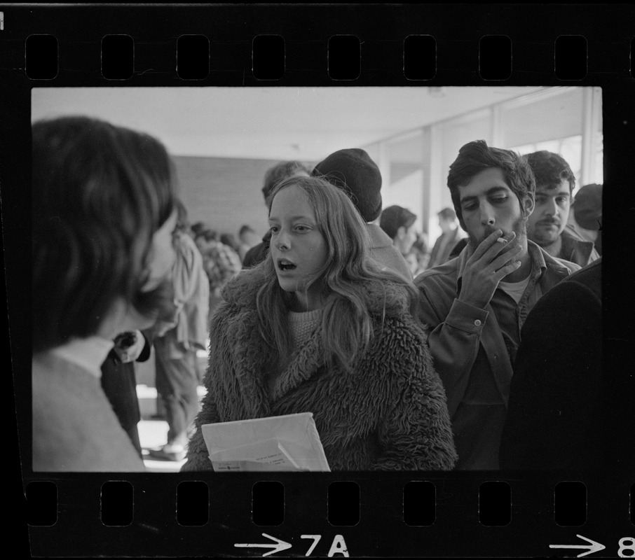 Brandeis University student speaks to another inside Bernstein-Marcus Administration Center during sit-in