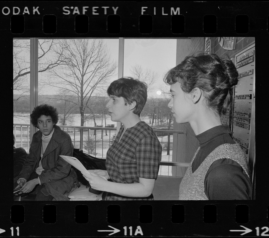 Student holds papers and speaks to a group inside the Bernstein-Marcus Administration Center during sit-in at Brandeis University