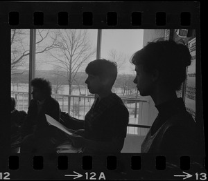 Student holds papers and speaks to a group inside the Bernstein-Marcus Administration Center during sit-in at Brandeis University