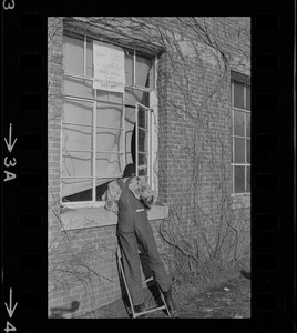 Reggie Sapp speaks to an occupier of Ford Hall through a window at Brandeis University during sit-in