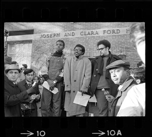 Reggie Sapp, Lloyd Daniels and Randall Bailey read the Ford Hall protesters' demands outside of Ford Hall during Brandeis University sit-in