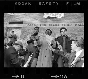 Reggie Sapp, Lloyd Daniels and Randall Bailey read the Ford Hall protesters' demands outside of Ford Hall during Brandeis University sit-in