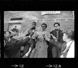 Reggie Sapp, Lloyd Daniels and Randall Bailey read the Ford Hall protesters' demands outside of Ford Hall during Brandeis University sit-in