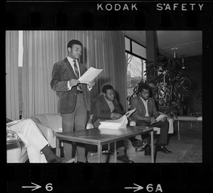 Leaders of the Black student protest at Brandeis University reading documents