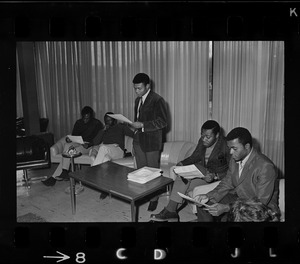 Leaders of the Black student protest at Brandeis University reading documents