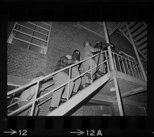 Men ascending stairs during sit-in at Brandeis University