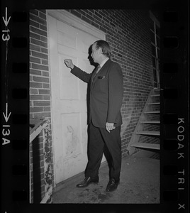 Man knocking at back door of Ford Hall during sit-in at Brandeis University