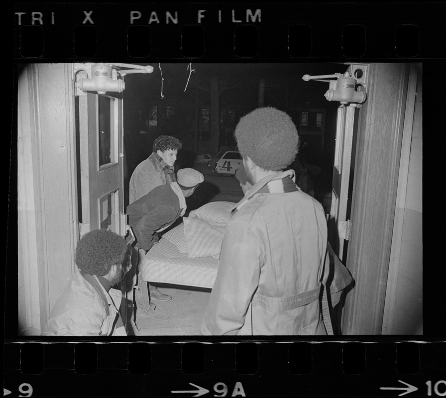 Brandeis University students carry mattress through Ford Hall door during Black student protest and occupation of the building