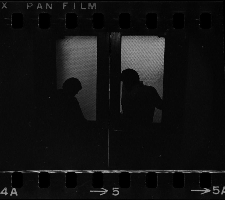 Silhouette of two people in front of door during student protest at Brandeis University