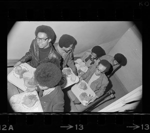 Black students at Brandeis University ascending stairs with trays of food during Ford Hall occupation