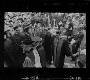 Brandeis University president Abram Sachar in procession and shaking a hand during commencement