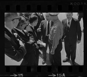 Stephen Golin, 26, of Leach Lane, Natick, a graduate student and Ph.D candidate speaking with a Waltham police officer and others at Brandeis University commencement