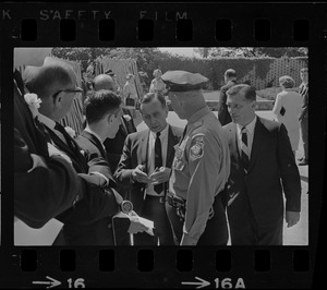 Stephen Golin, 26, of Leach Lane, Natick, a graduate student and Ph.D candidate speaking with a Waltham police officer and others at Brandeis University commencement