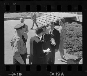 Stephen Golin, 26, of Leach Lane, Natick, a graduate student and Ph.D candidate speaking with a Waltham police officer and others at Brandeis University commencement