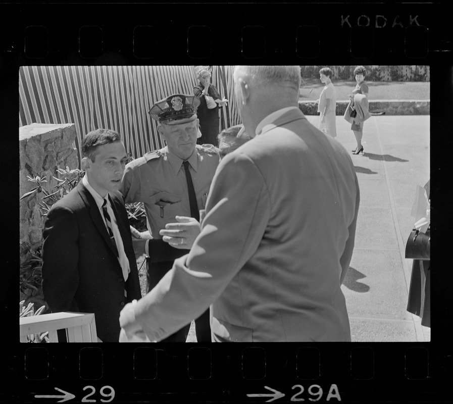 Stephen Golin, 26, of Leach Lane, Natick, a graduate student and Ph.D candidate in conversation with Waltham police officer of the at Brandeis University commencement