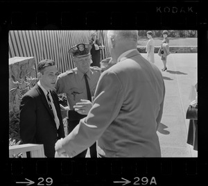 Stephen Golin, 26, of Leach Lane, Natick, a graduate student and Ph.D candidate in conversation with Waltham police officer of the at Brandeis University commencement