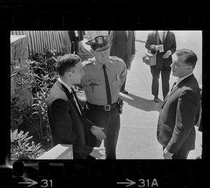 Stephen Golin, 26, of Leach Lane, Natick, a graduate student and Ph.D candidate in conversation with Det. Arthur McGonigle and another officer of the Waltham police at Brandeis University commencement