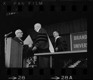 Brandeis University President Abram L. Sachar awarding an honorary degree to Henry Townley Heald, former president of the Ford Foundation at commencement