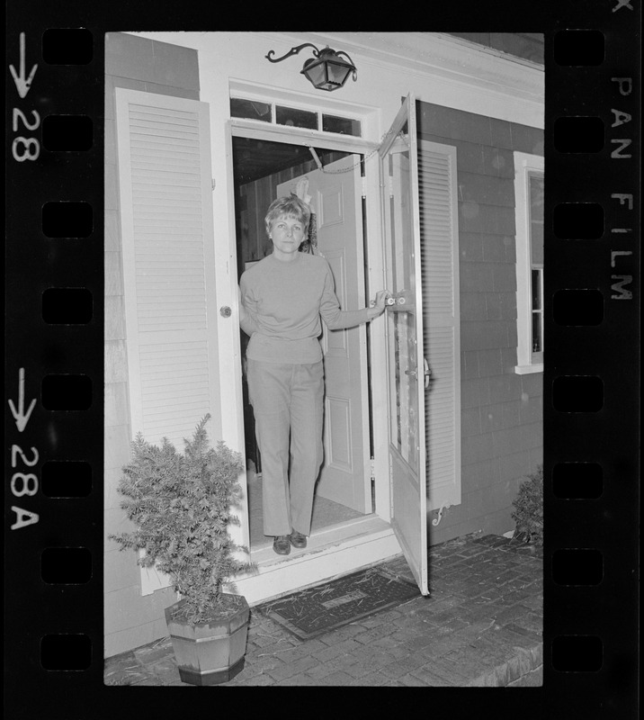 Mrs. Carol North, POW wife, standing in the doorway of her Wellfleet home