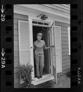 Mrs. Carol North, POW wife, standing in the doorway of her Wellfleet home