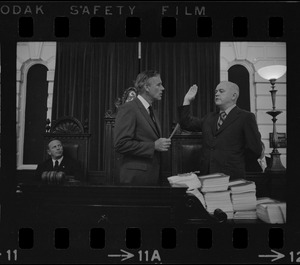 Judge Edward F. Hennessey takes oath of higher level of office from Governor Francis Sargent at the Senate Chambers in the State House