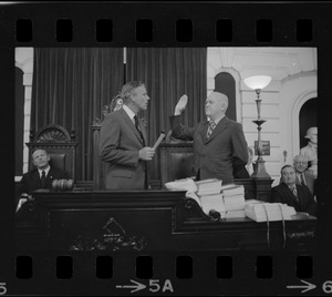 Judge Edward F. Hennessey takes oath of higher level of office from Governor Francis Sargent at the Senate Chambers in the State House