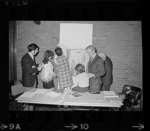 Mayor Kevin White seen with family members of POW's at Boston City Hall while they hang posters to raise awareness of the plight of the Gas being held by North Vietnam