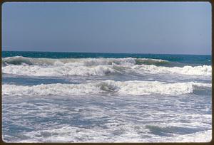 Ocean waves with buoy in distance