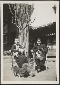 Ida Pruitt sitting with woman and four dogs