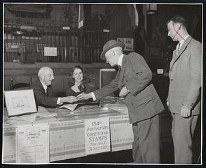 Portrait of Boston—Charles Francis Adams sells Allan Forbes a three-cent stamp at the State Street Trust. With them is Miss Dixie Arnold, who will sell the new ‘Old Ironsides” stamp at the bank for the next few days.