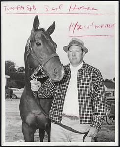 The Range. A year ago today this horse, Good Bird, roamed the wilds of Western Colorado where cowpokes called him "The Ghost of the Range." Today The Bird is one of the top horses at Rockingham. He is shown here with trainer L.E. Seba.