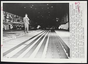 All Alone - Harris Innis, superintendent of the Clairton rolling mill of the U.S.Steel company, stands alone today on the run-out table of the mill's 18-inch mill as the scheduled steel strike curtailed more and more steel production throughout the nation. Narrow plates, shown cooling here on the mill's hot beds, will remain there for the duration of the strike, set for midnight tonight.