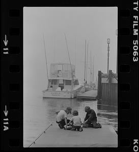 Fog in harbor and boys fishing