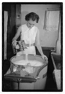 A woman doing laundry with a washing machine