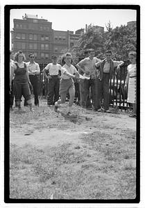 Two young women playing horseshoes