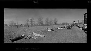 Boston University students enjoy the spring sun by Charles River, Boston