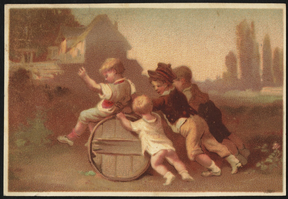 Four boys - three pushing a barrel, one riding on top of it.